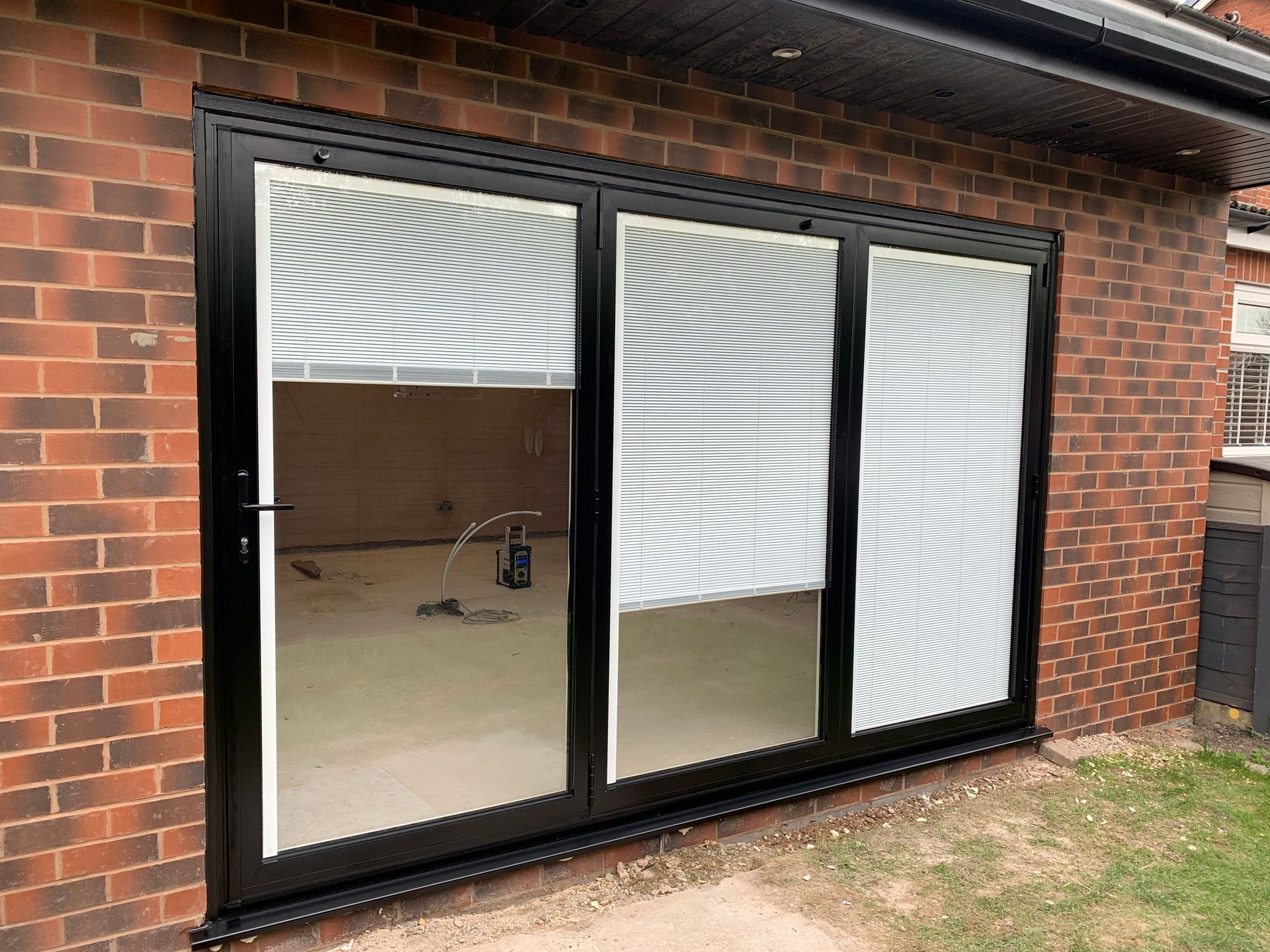 black aluminium bifolding doors in prestwhich whitefield with blinds inside glass
