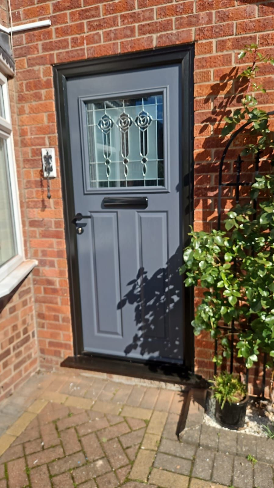 Grey front door with black frame