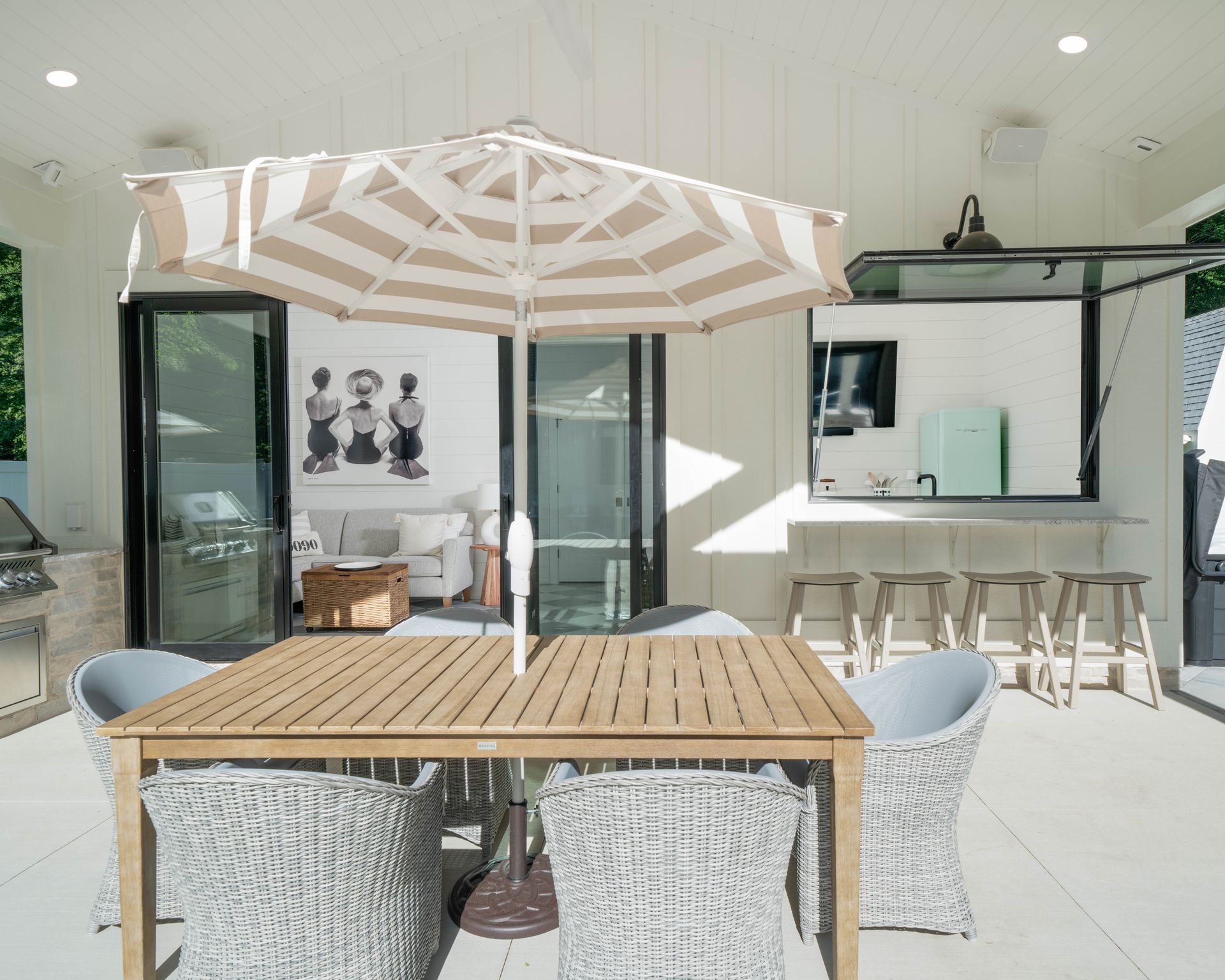 A patio with a table and chairs and an umbrella
