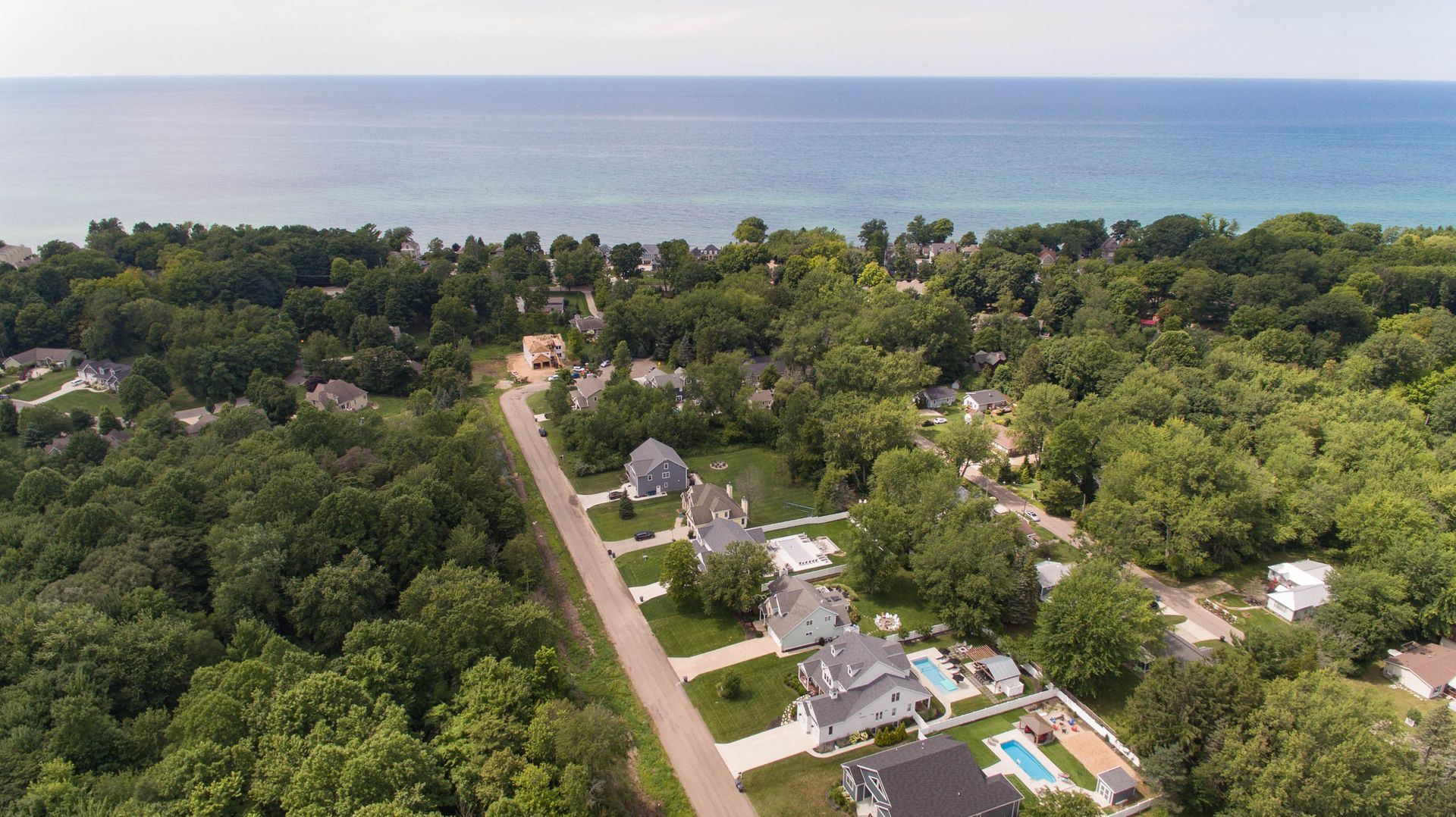An aerial view of a residential area next to the ocean.