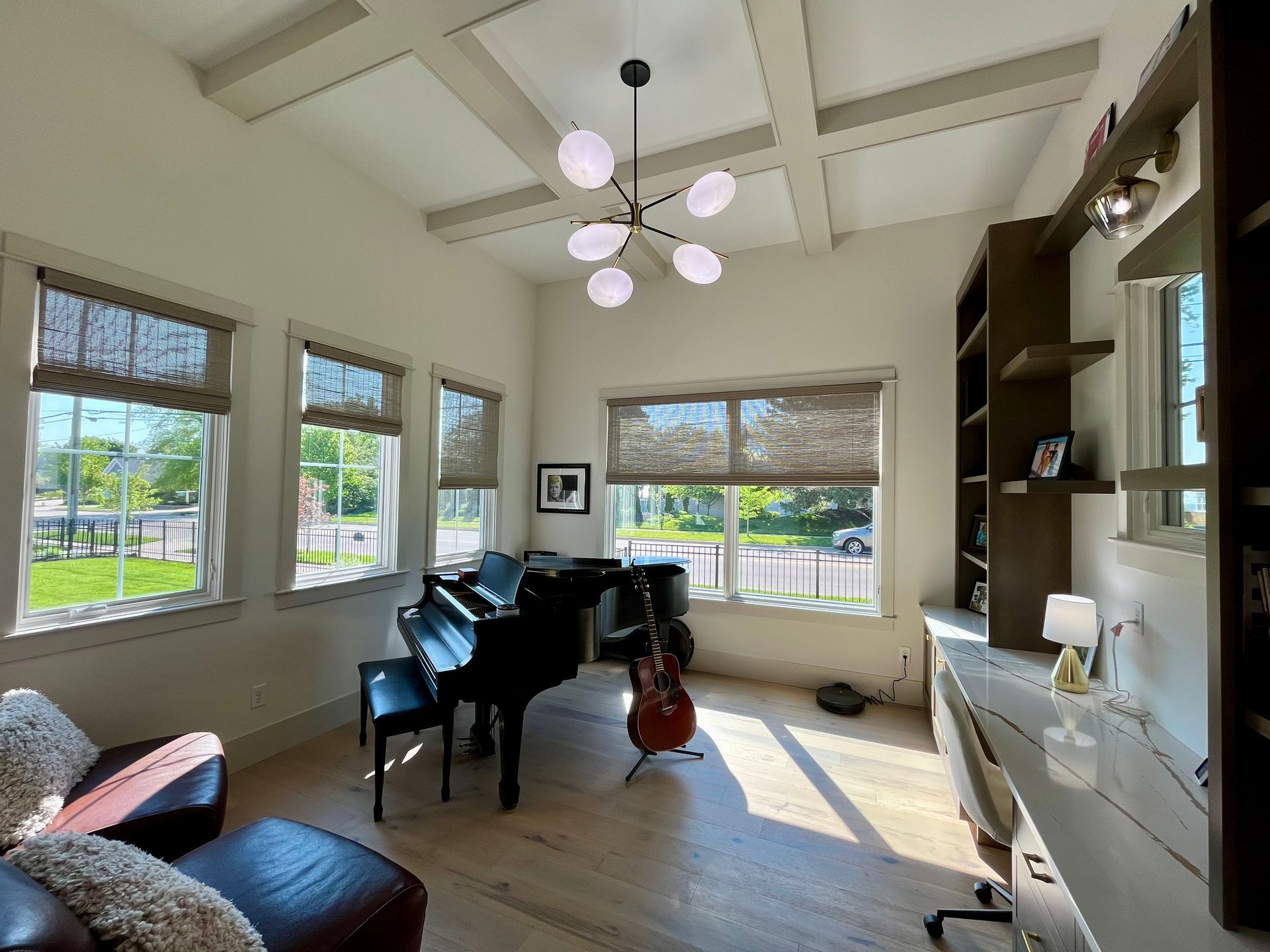 A living room with a piano and a guitar in it