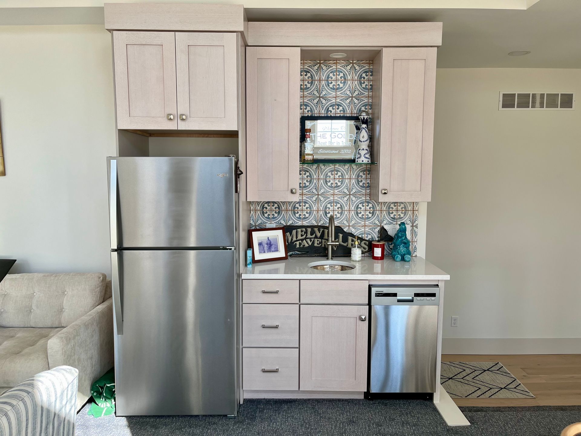 A kitchen with stainless steel appliances and white cabinets