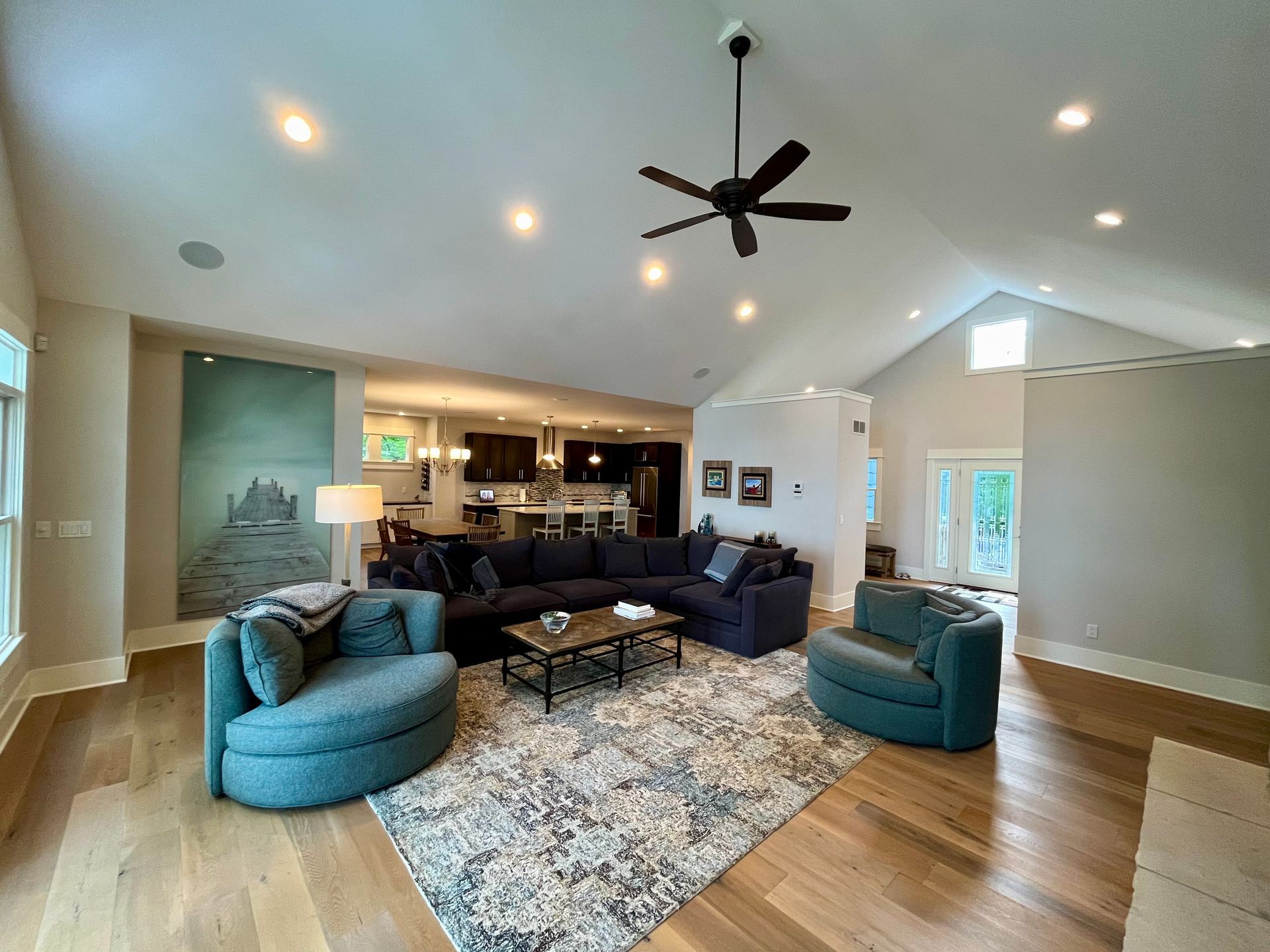 A living room filled with furniture and a ceiling fan.