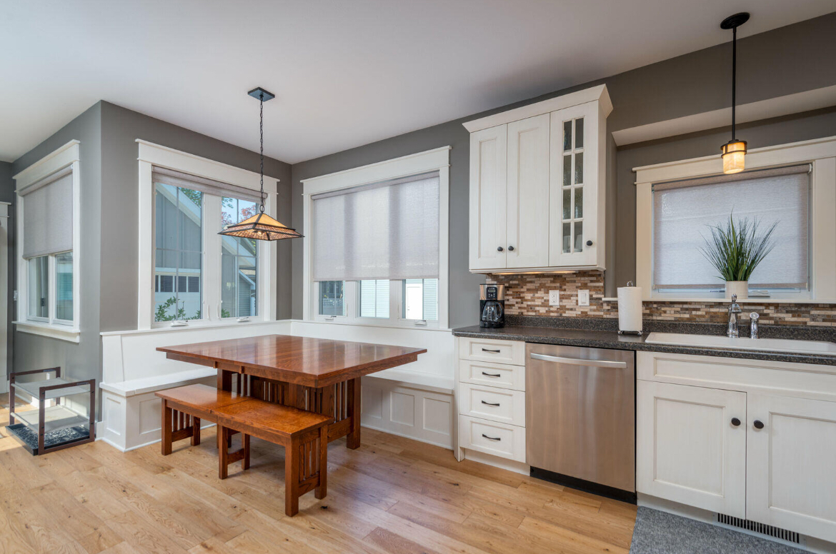 A kitchen with a table and bench in the corner.