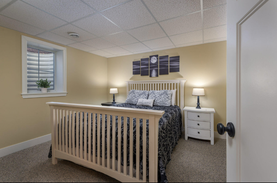 A bedroom with a large bed and two nightstands