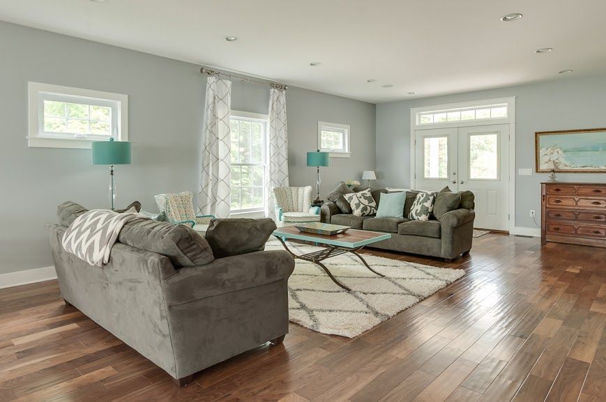 A living room filled with furniture and a rug.