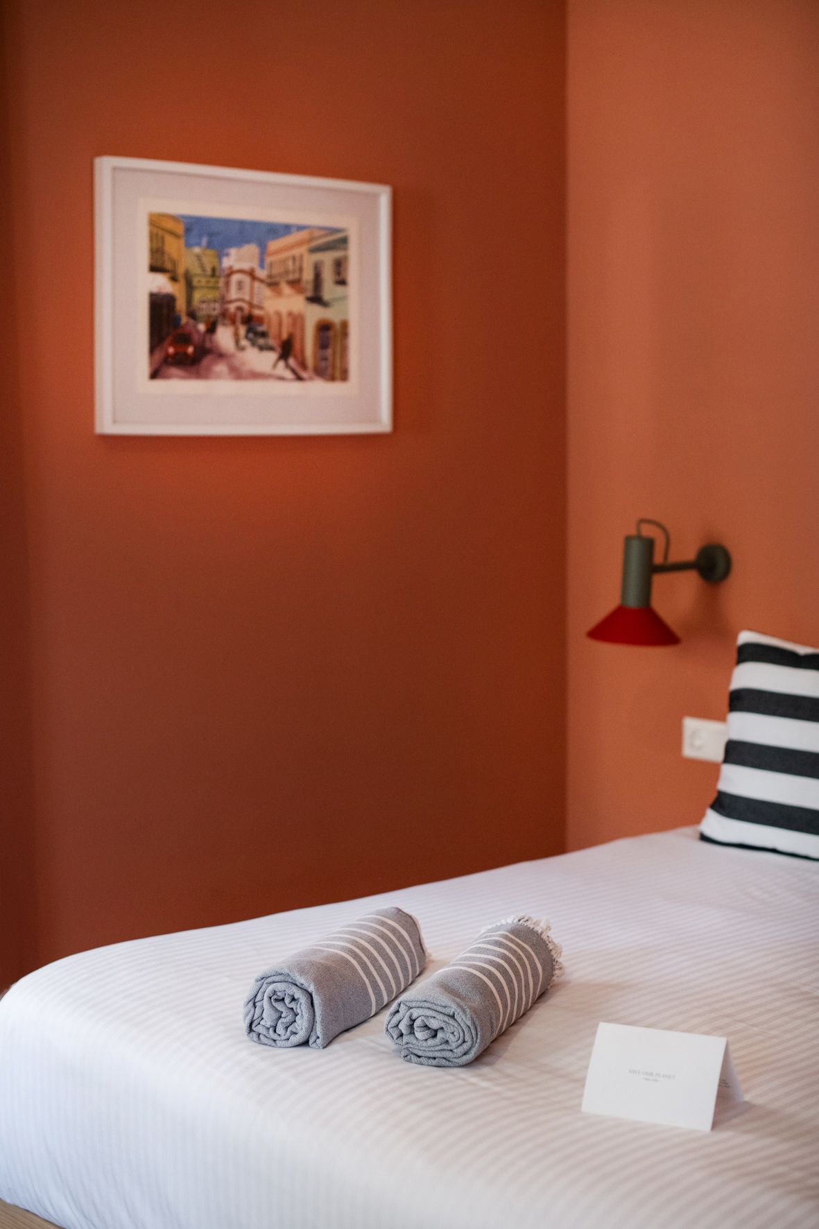 there is a picture on the wall above the bed .