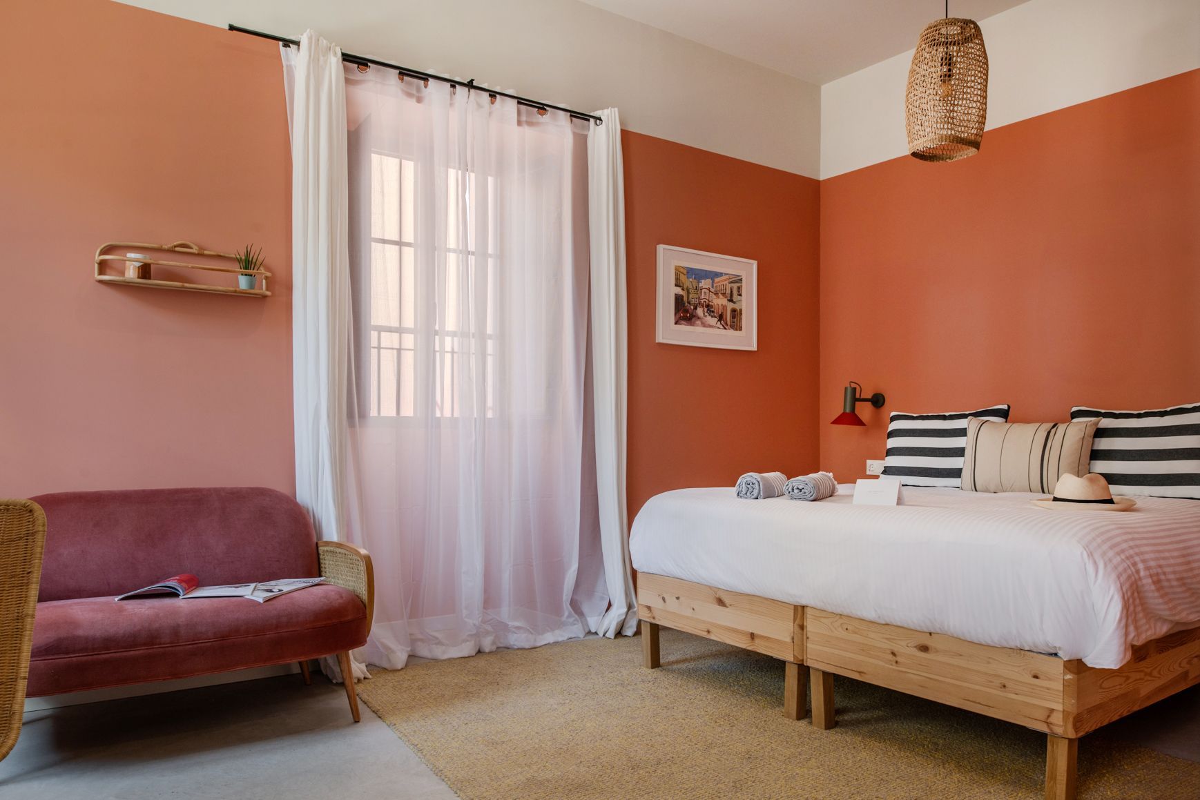 There is a bed and a couch in the room.