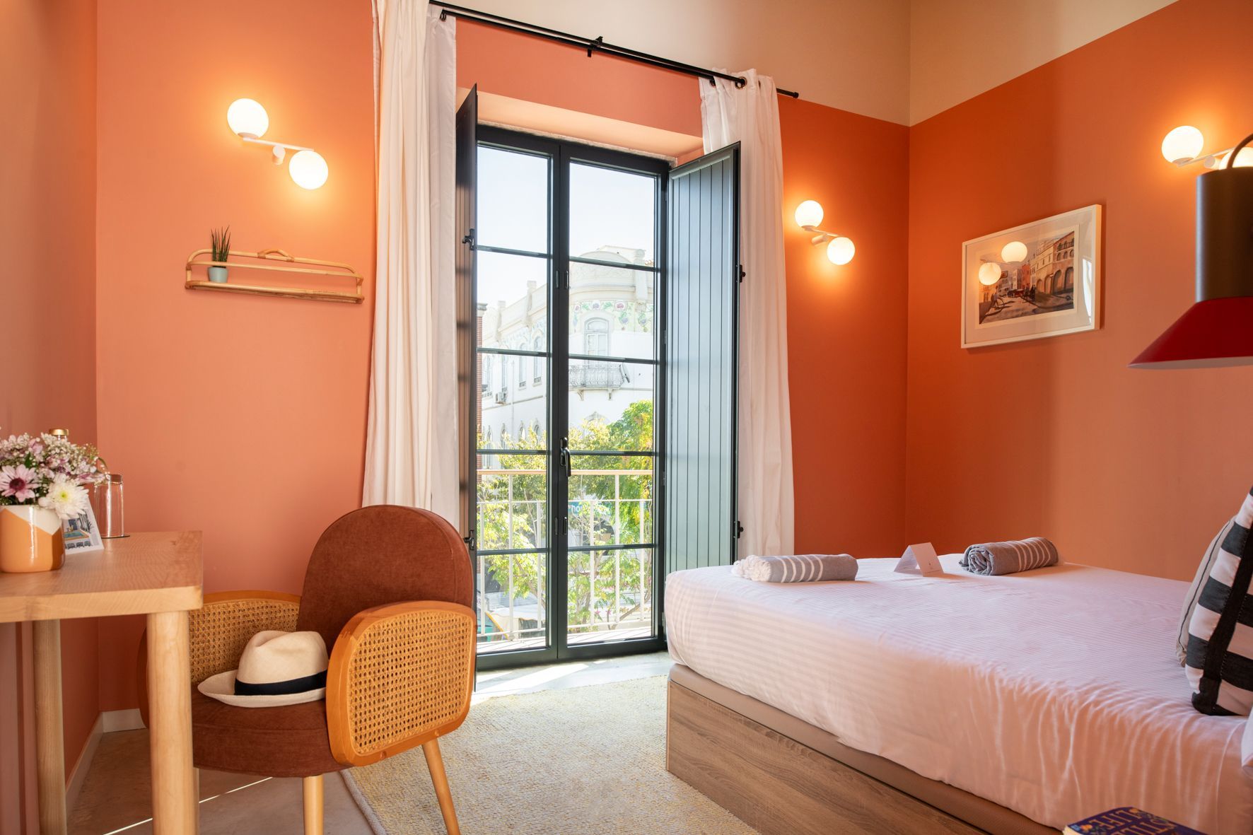 A bedroom with a bed , chair , desk and window.