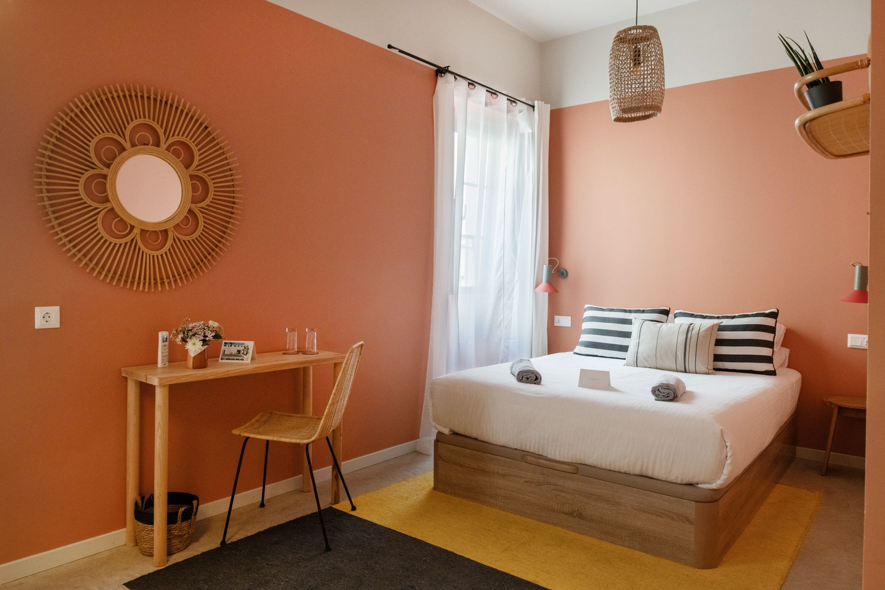 A bedroom with a bed , desk and chair.