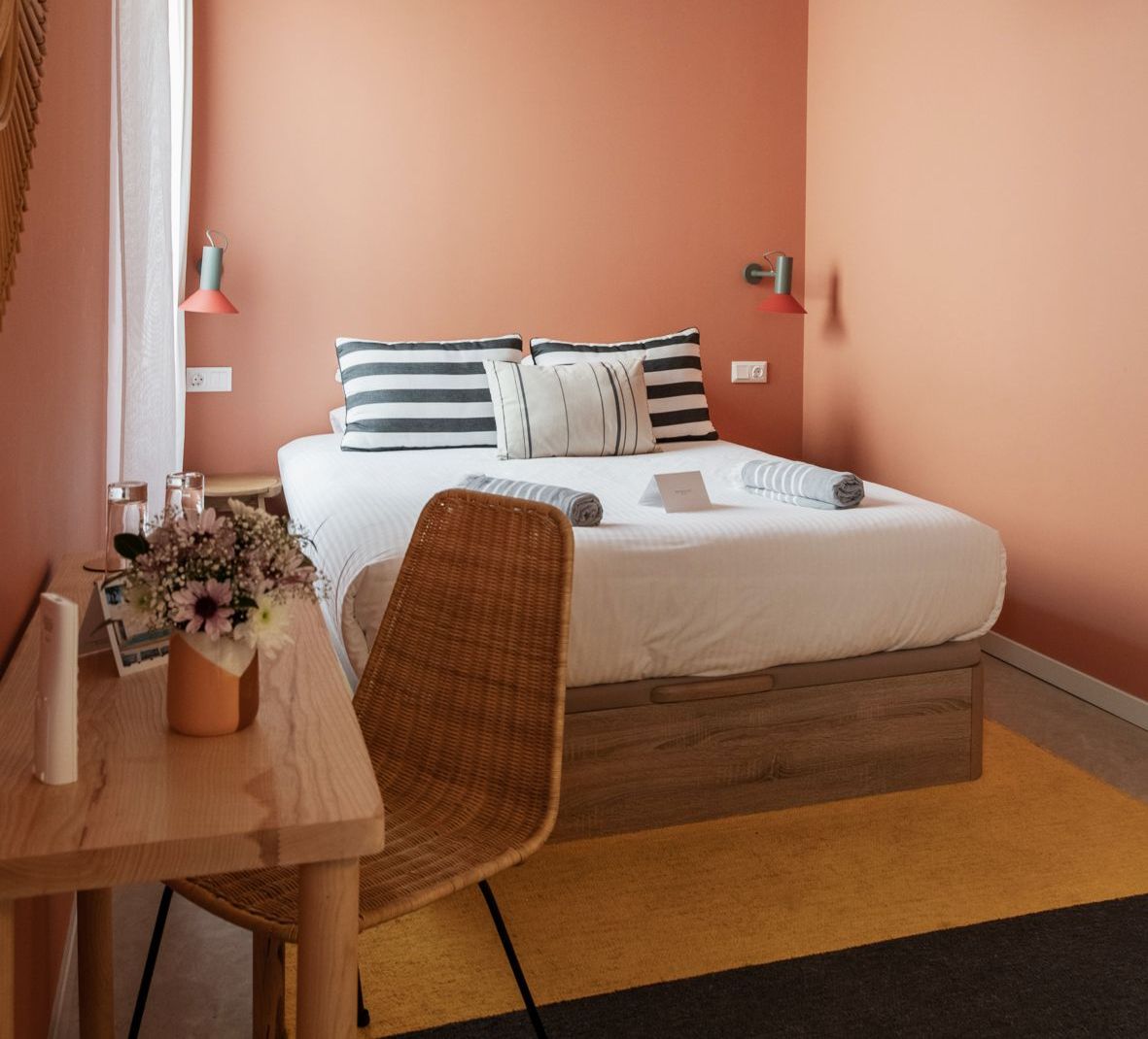 A bedroom with a bed a desk and a chair