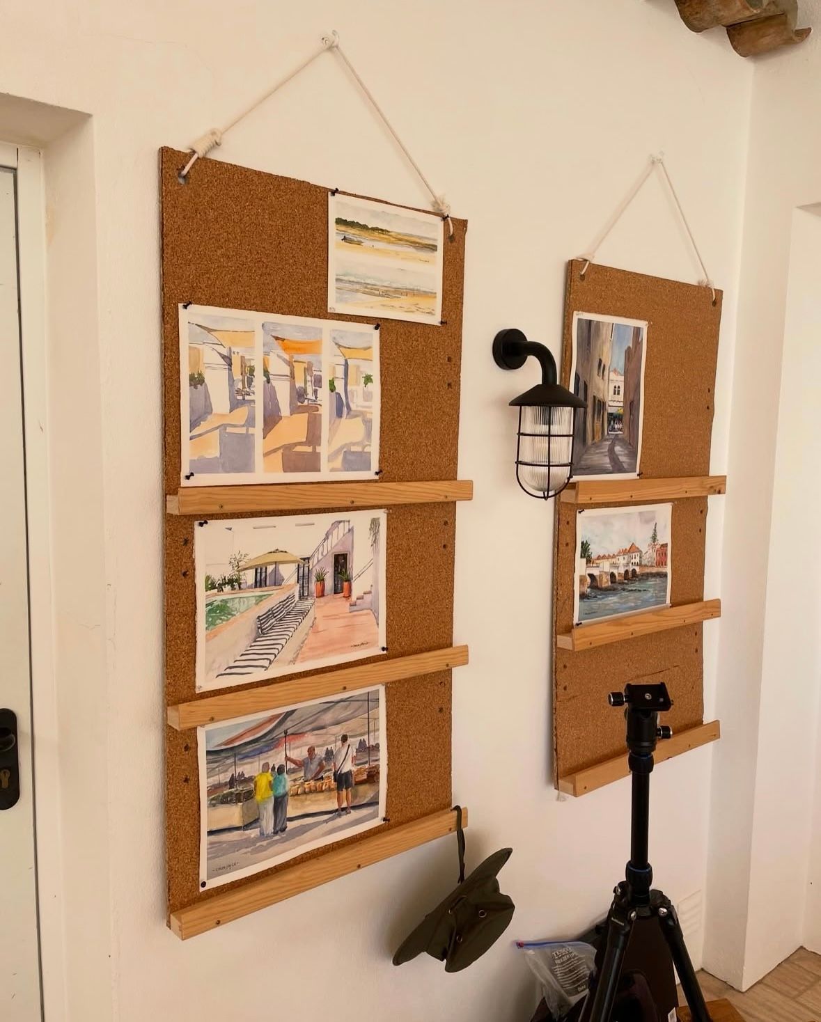 A cork board with pictures on it hanging on a wall