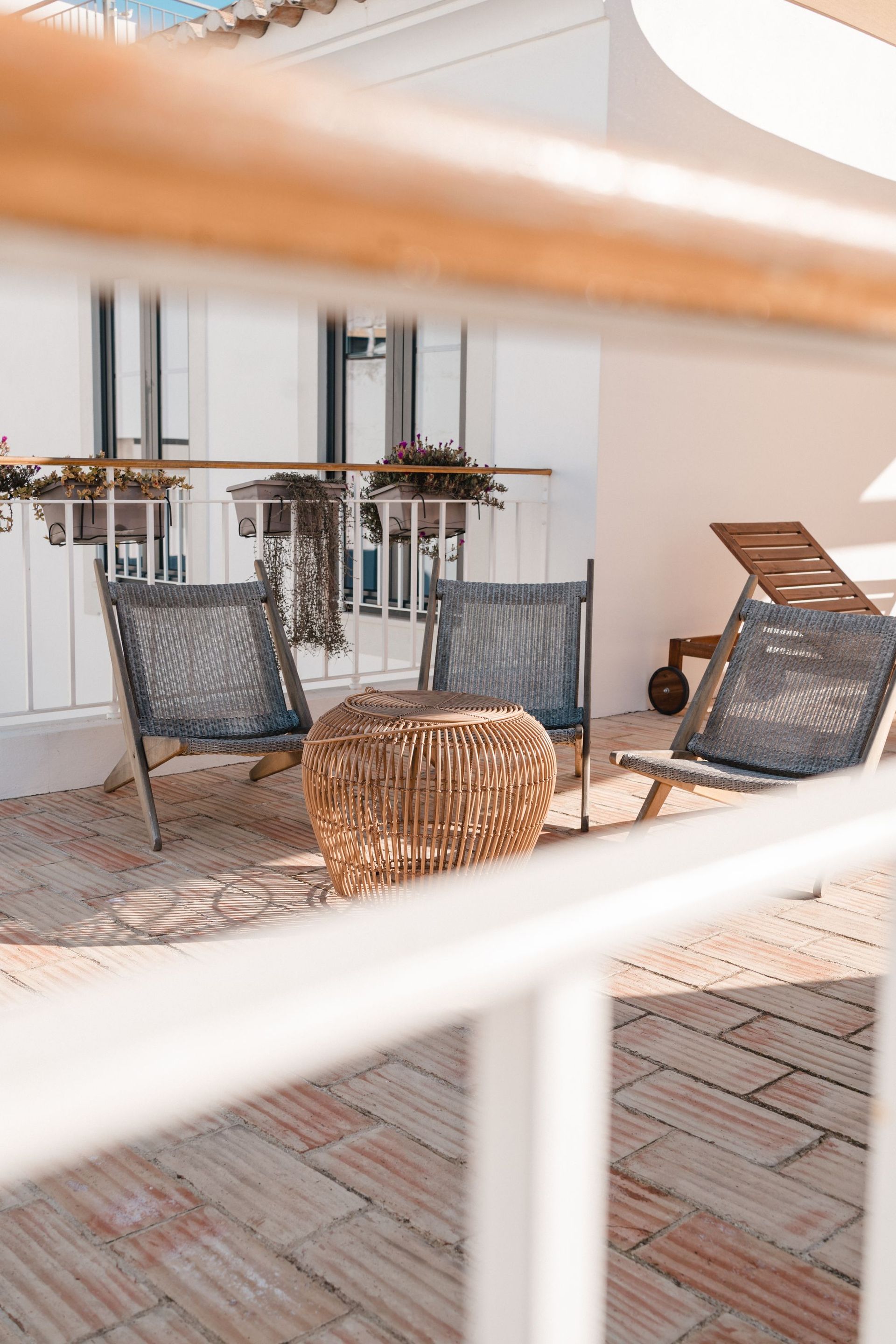 A balcony with chairs and a table on it.