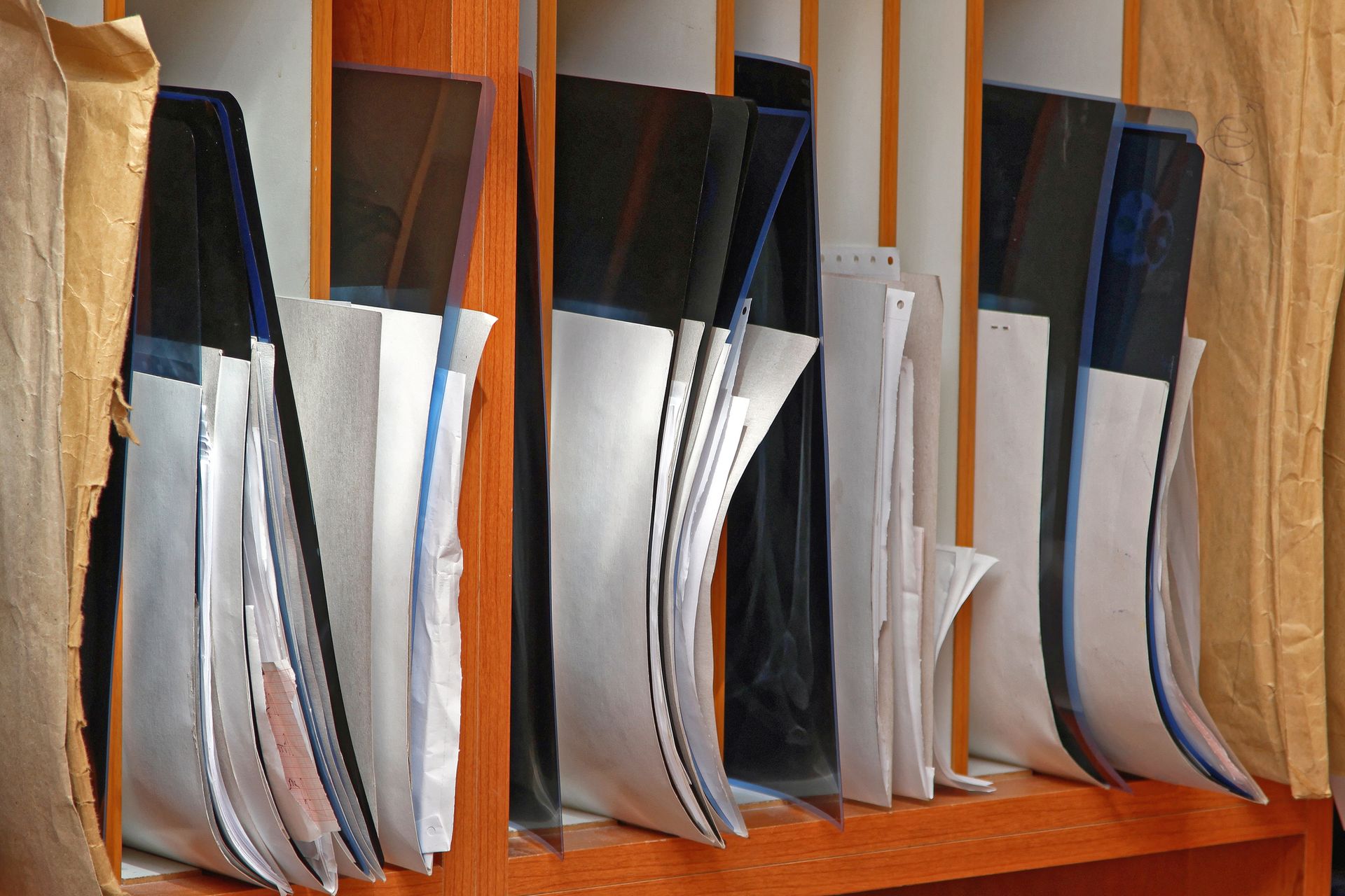 Papers in brown wooden dividers.