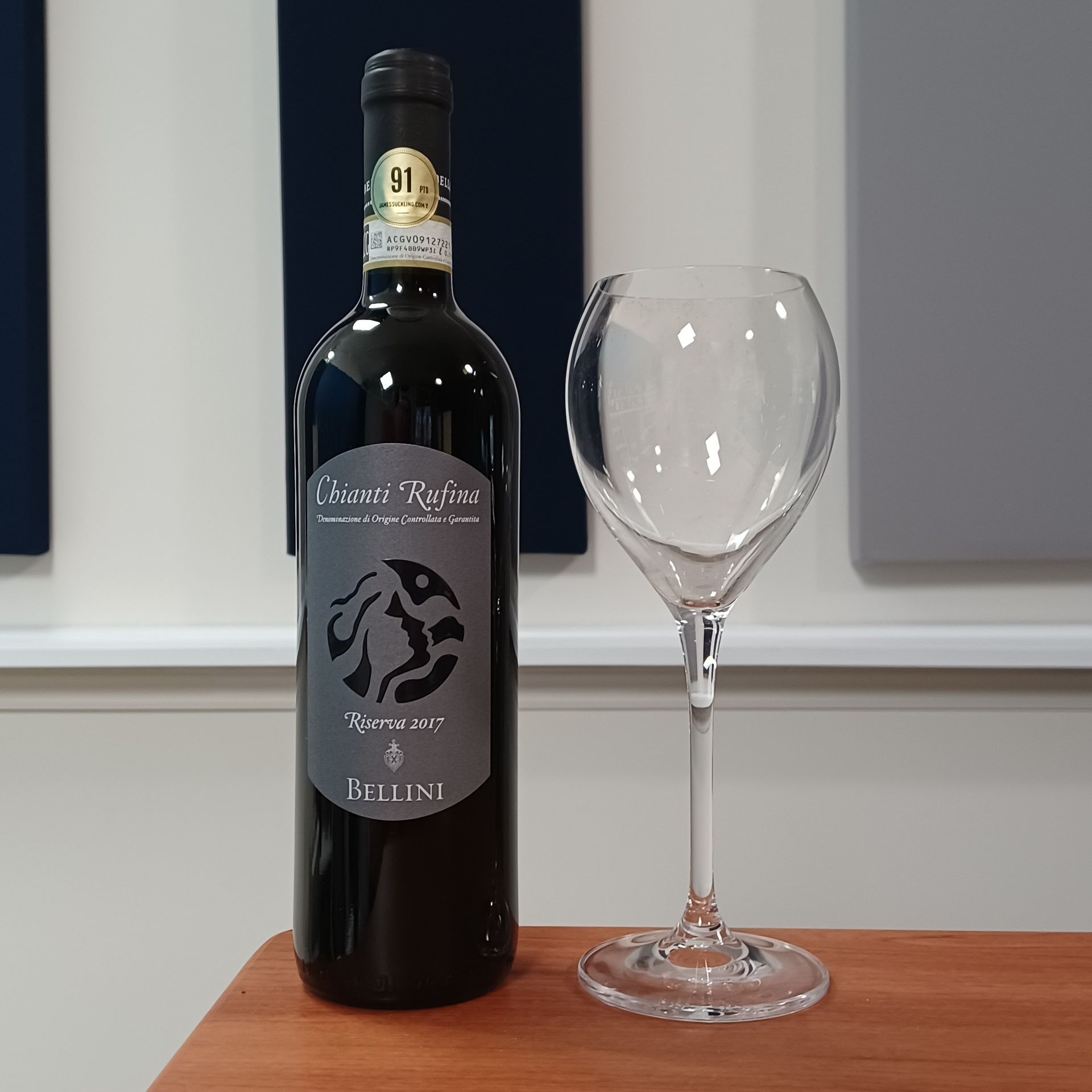 Bottle of Grande Absente absinthe liqueur, green and white label, set on dried herbs.