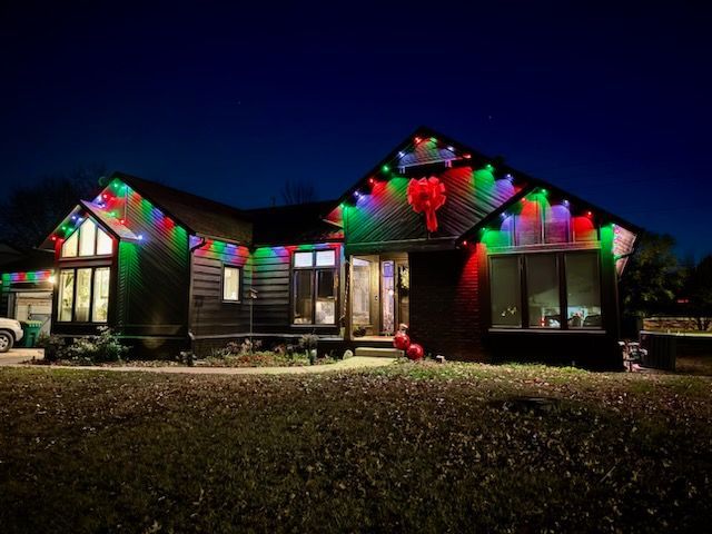 A house is decorated with christmas lights at night.
