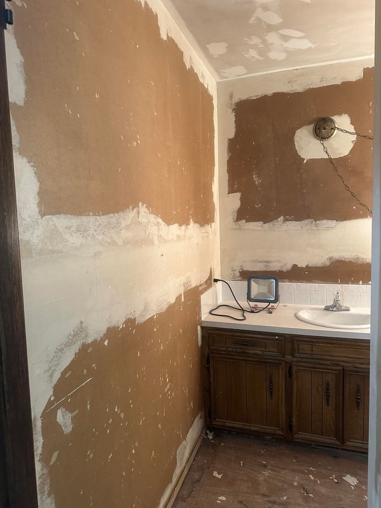 A bathroom with a sink and cabinets is being remodeled.