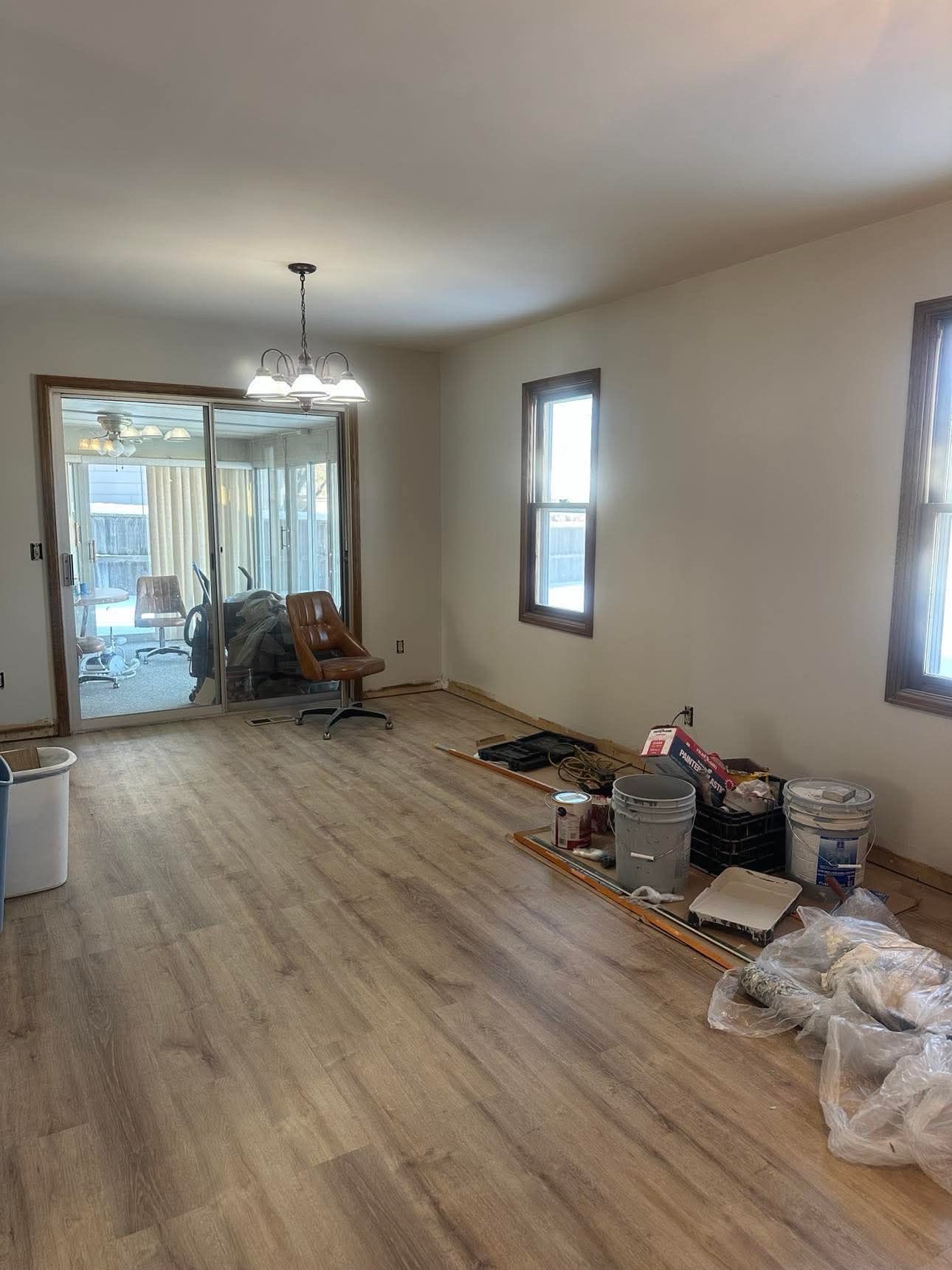A living room with hardwood floors and a sliding glass door.