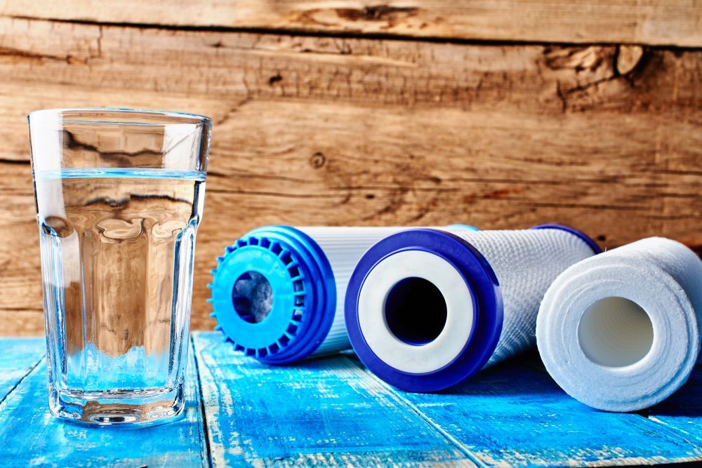 Glass of Water With Water Filters on a Blue Surface — Oxplumb in Coolum Beach, QLD
