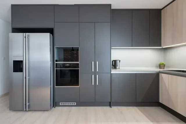Modern Kitchen with Stainless Steel Refrigerator and Built in Wall Oven — Central Coast Washing Machines & Refrigerator Repairs in San Remo, NSW