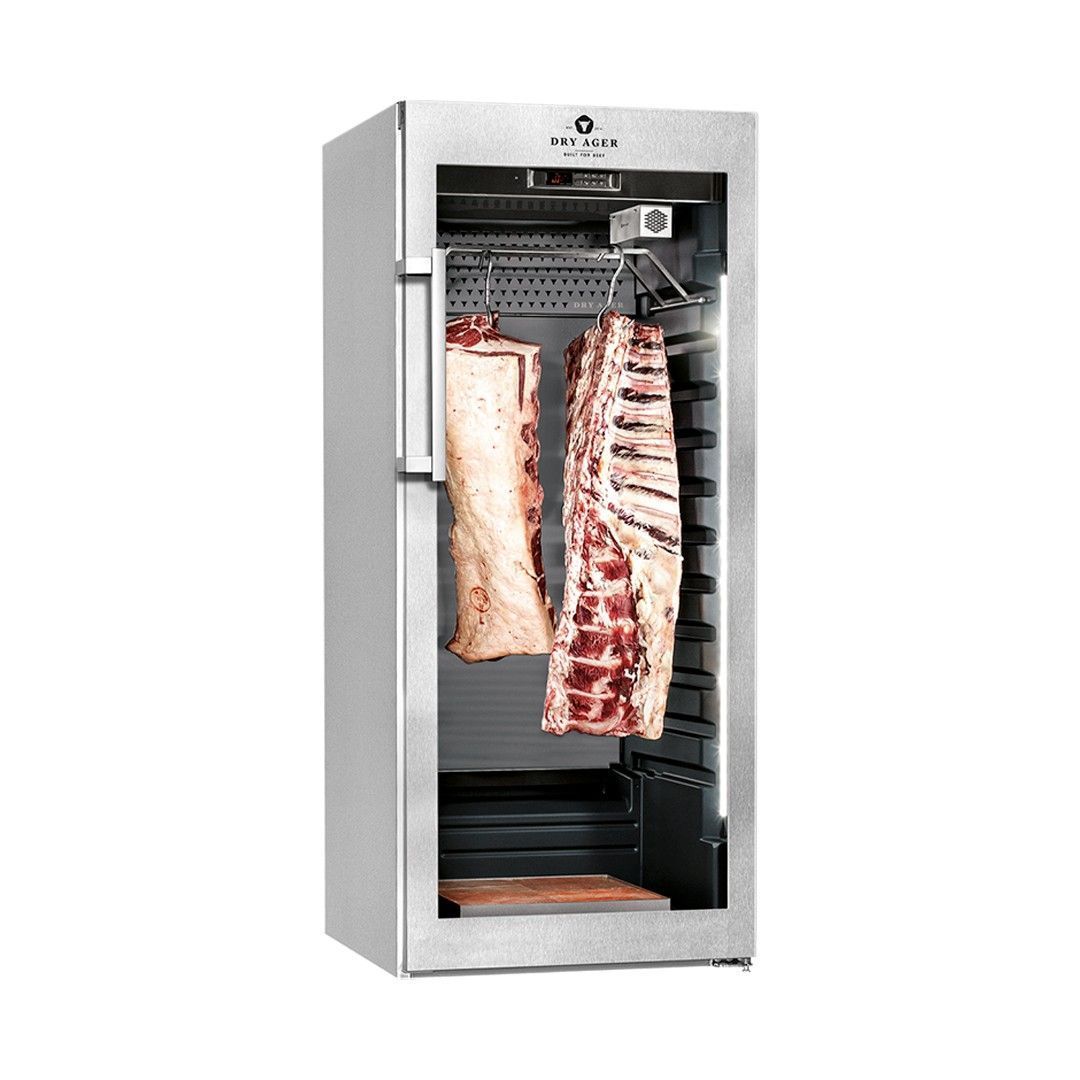 Refrigerador de maduración en seco de acero inoxidable con dos grandes cortes de carne colgados en su interior.