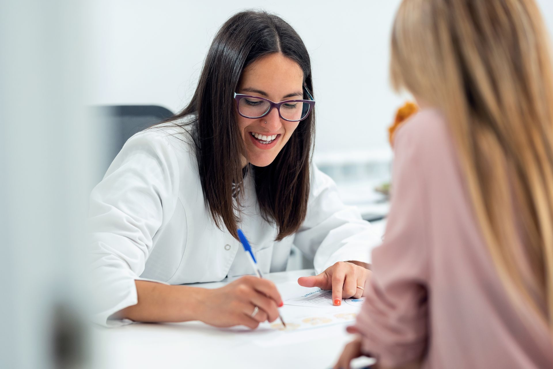 A doctor is at a consult with a patient.