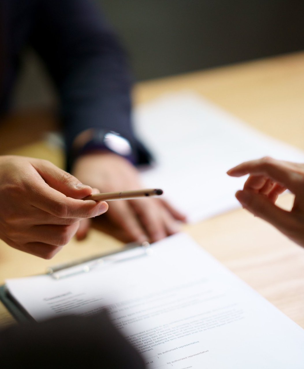 Guy handing a pen to client to sign - PYA Insurance Brokerage in Ontario, CA Guy handing a pen to client to sign - PYA Insurance Brokerage in Ontario, CA