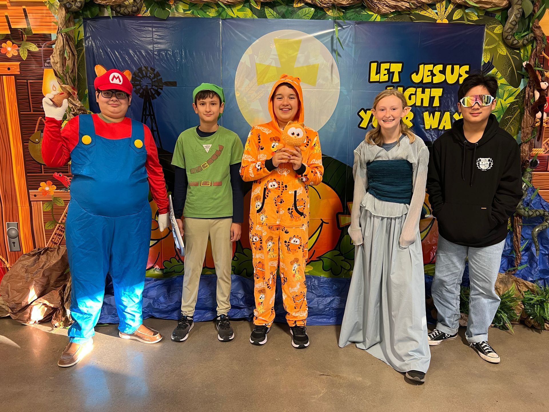 A group of people dressed in costumes are posing for a picture.