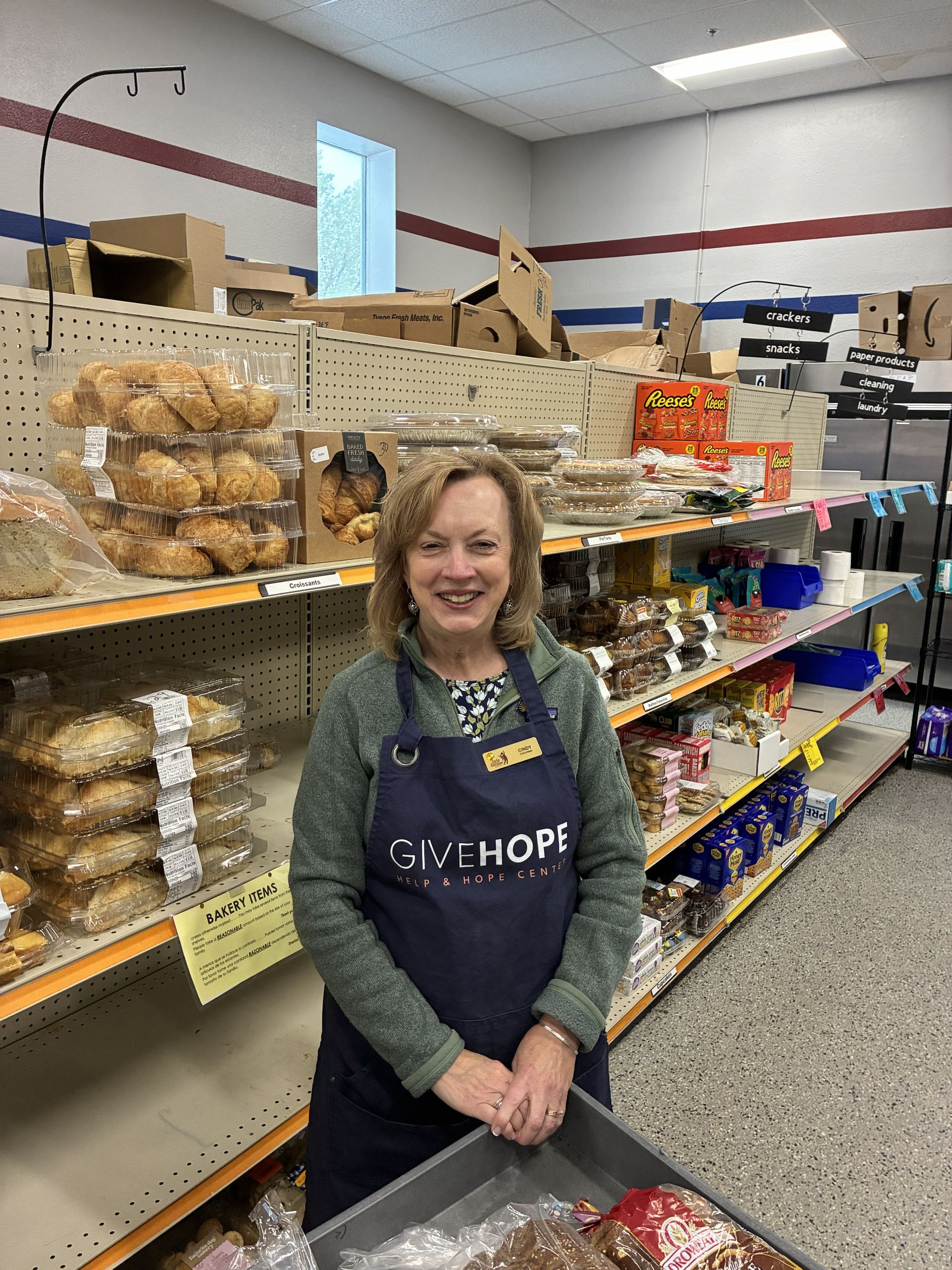 Volunteer, Cindy Hazlehurst stocking shelves of food pantry. 