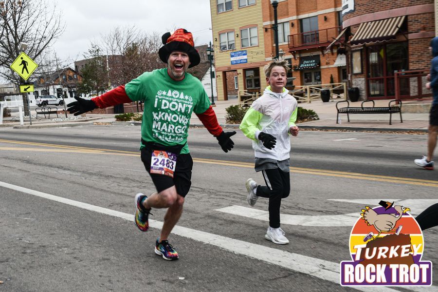 A man in a green shirt in the Turkey Rock Trot in Castle Rock
