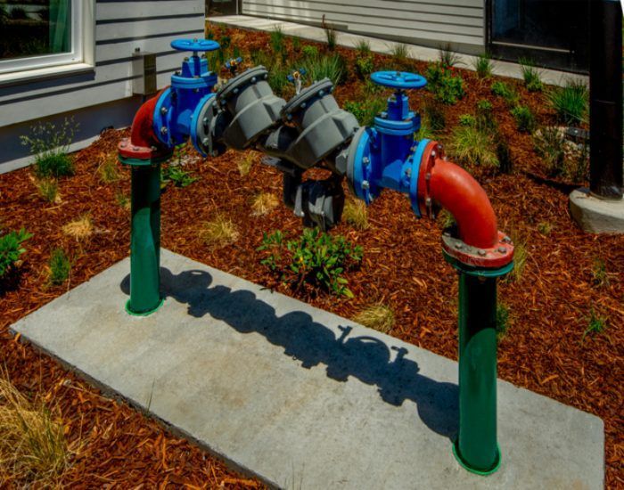 An outdoor valve assembly & exposed pipes showing backflow prevention services in Franklin Park, IL