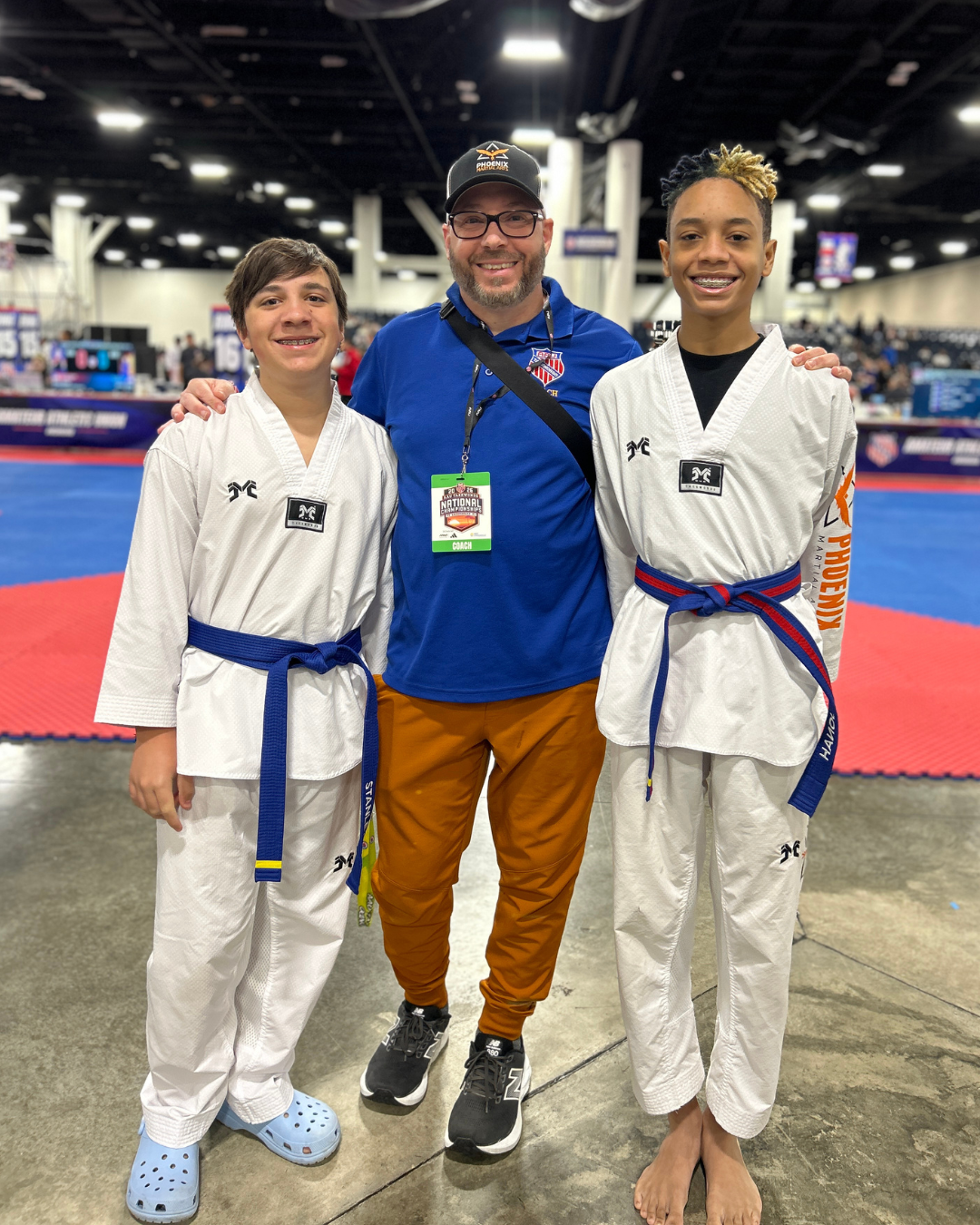 Coach with Taekwondo athletes at a national tournament