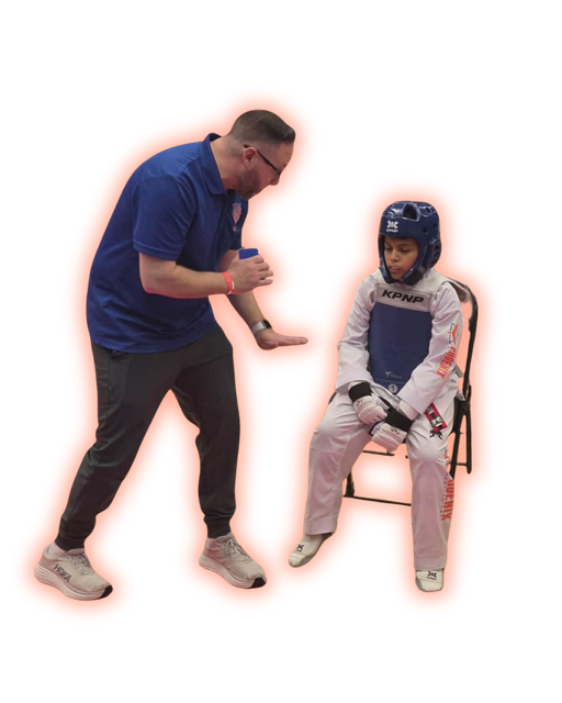 Coach mentoring a young Taekwondo athlete before competition