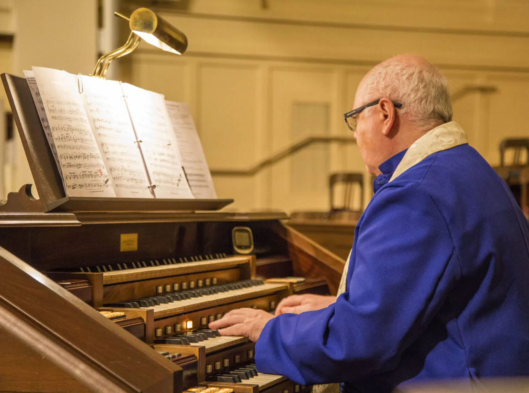 A picture of John Walko, organist, playing at the organ in the Sanctuary