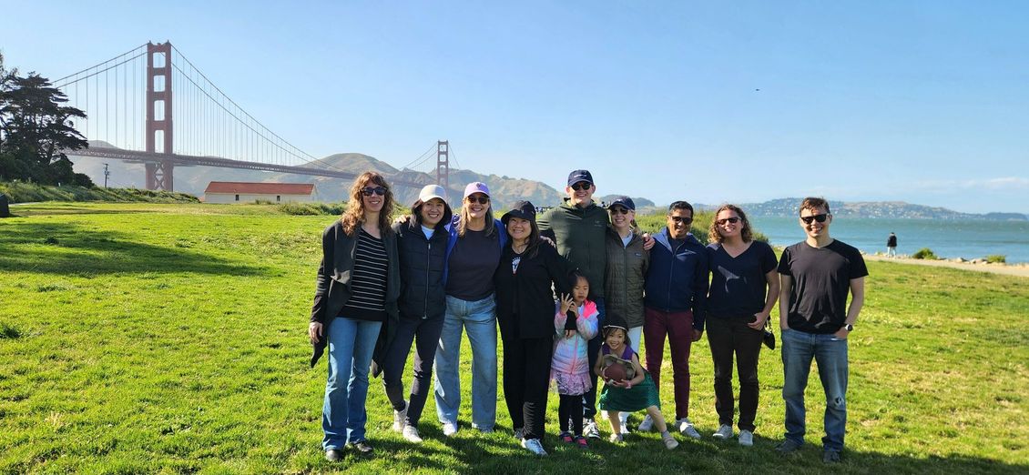Calvary Young Adults (20s & 30s) at Chrissy Field for Boba and Fellowship. They are posing for a picture in front of the Golden Gate Bridge
