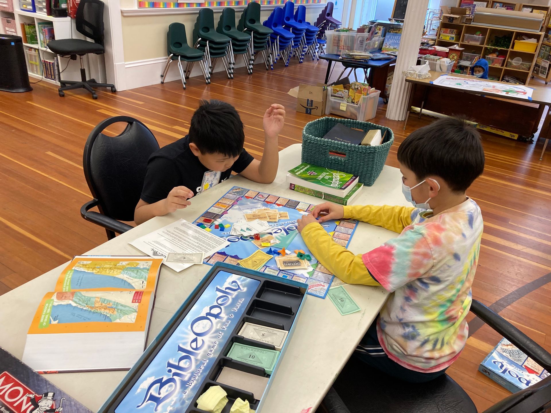 Two children playing a board game in the lower level