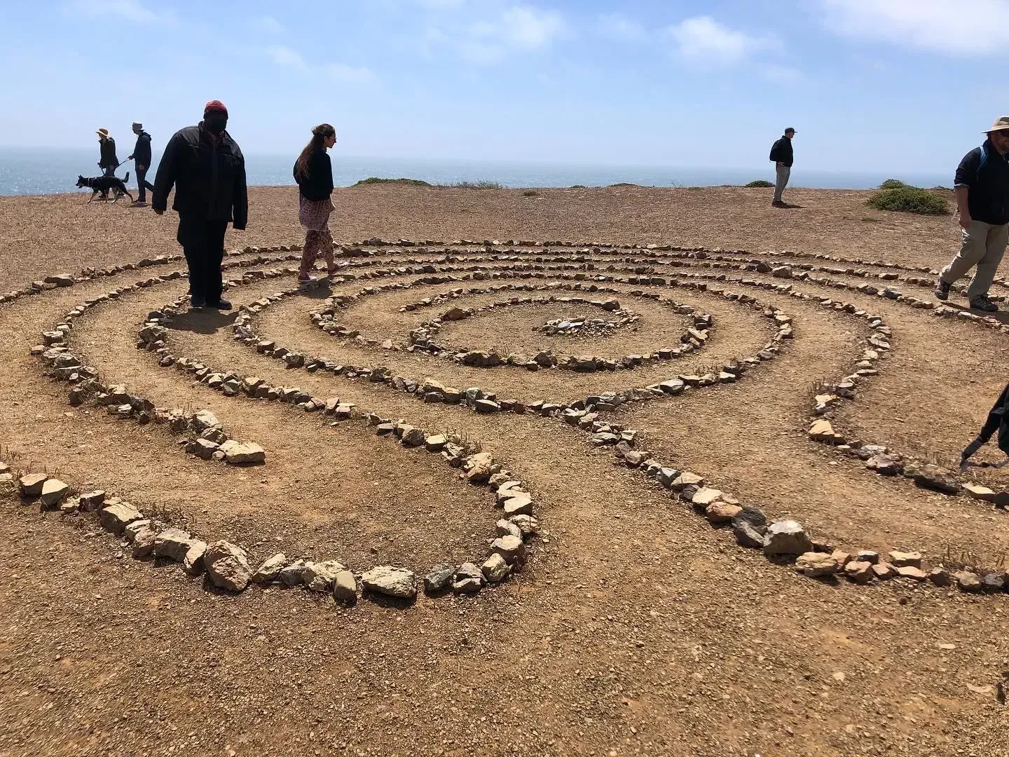 People walking a stone labyrinth