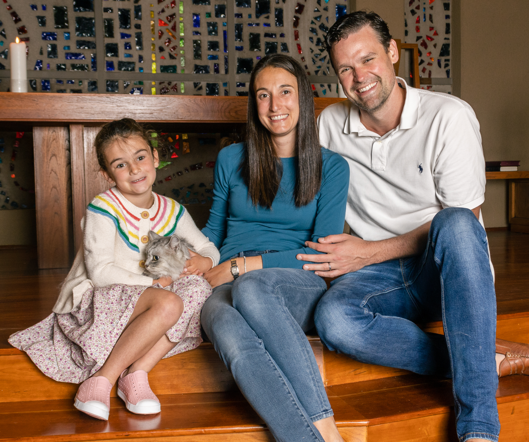 A family on the Chapel steps holding their cat