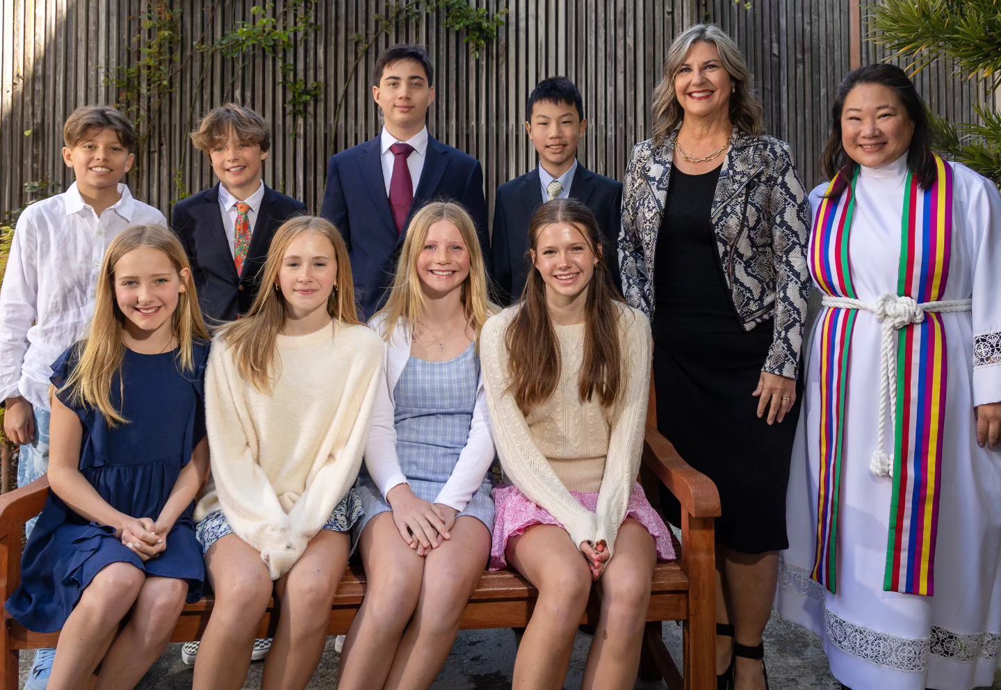 Confirmation class of 2023 taking a happy but more serious photo in the garden