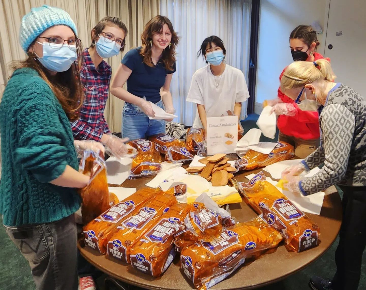 A group of youth aged 12-17 making sandwiches for pack-a-sack