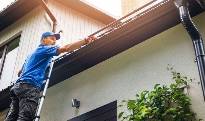 Man Cleaning Roof — Renton, WA — Alpine Gentle Roof Cleaning Man Cleaning Roof — Renton, WA — Alpine Gentle Roof Cleaning