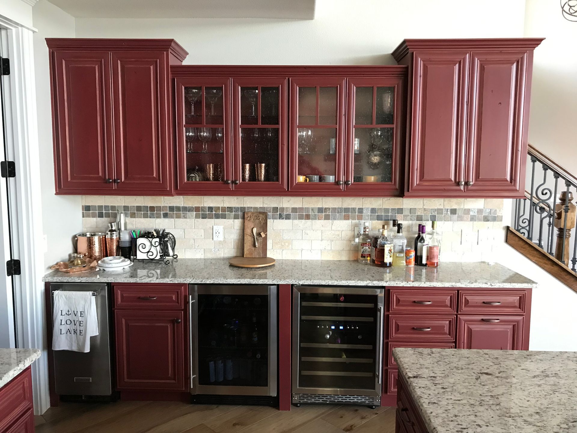 Cherry wood kitchen cabinets with glass fronts, granite countertop, and stainless appliances
