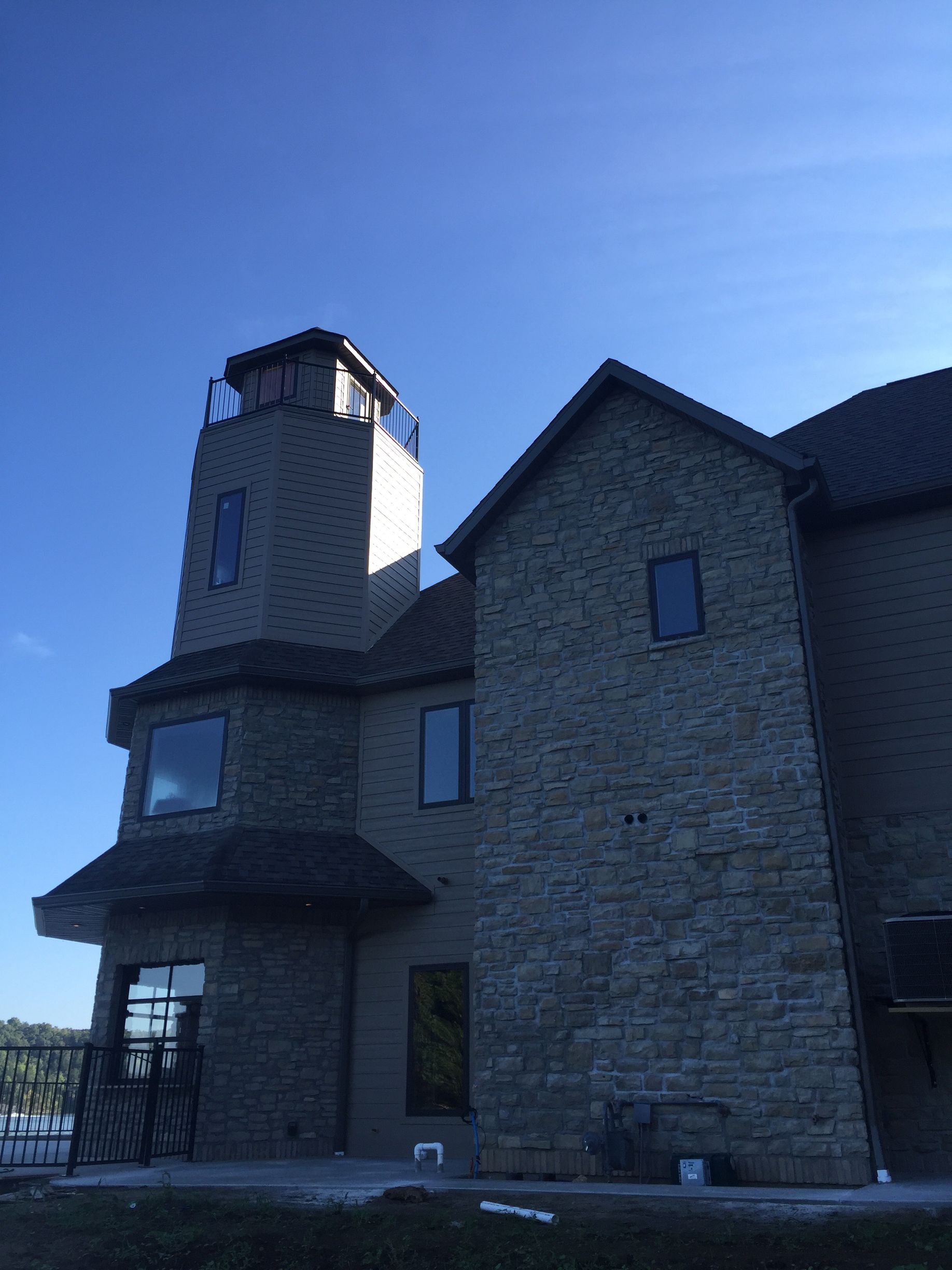 Stone building with a tower against a clear blue sky