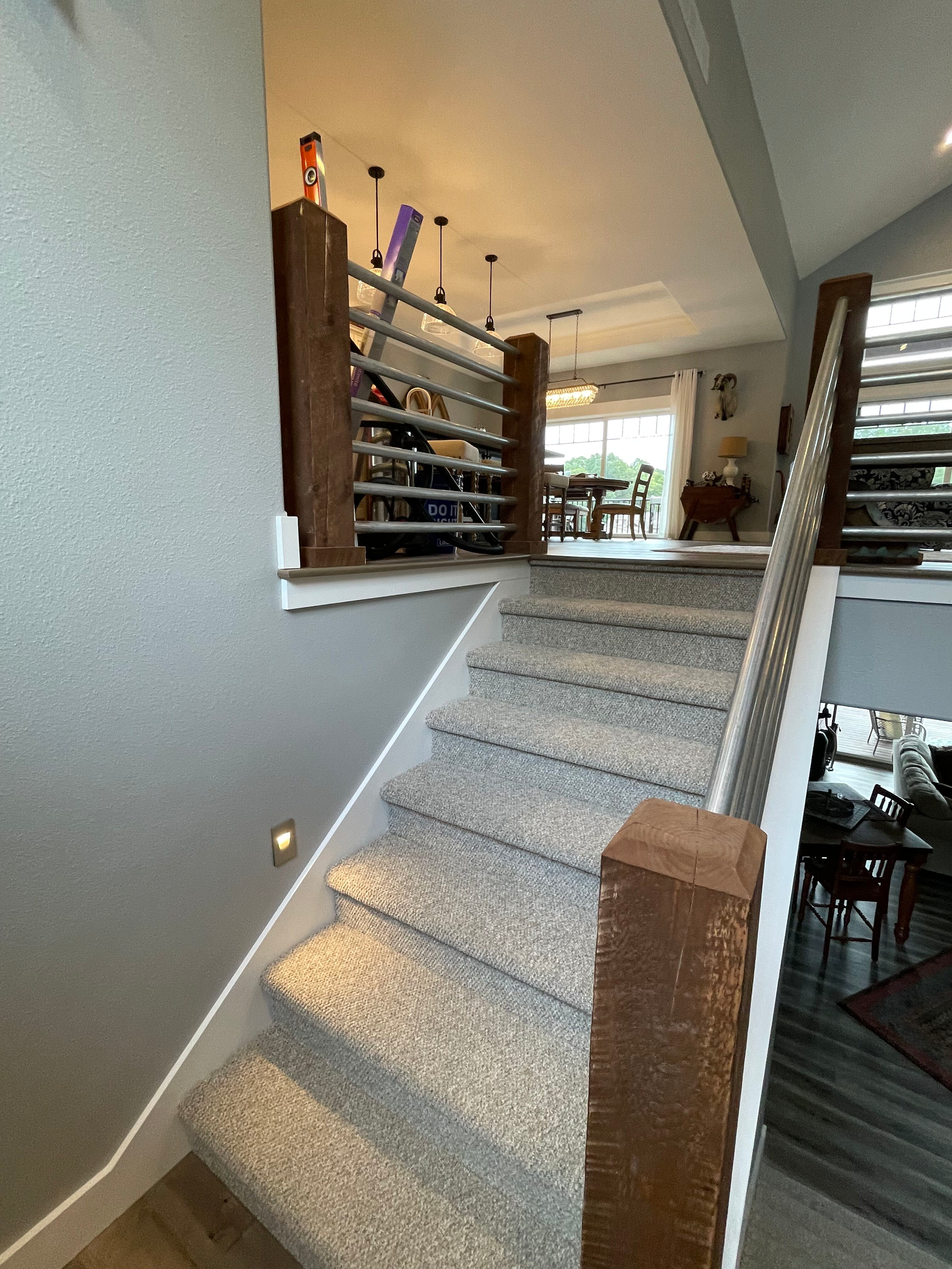 Carpeted staircase with wooden railing in a modern home interior