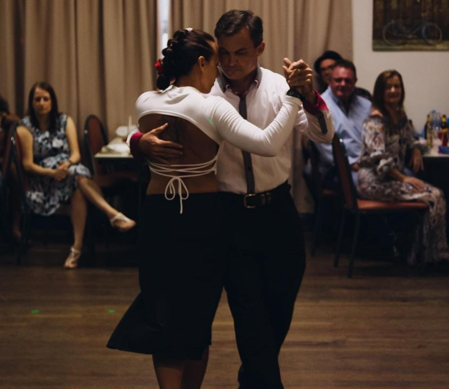 A Man And A Woman Are Dancing In Front Of A Crowd — Global Dance Collective In West End, QLD