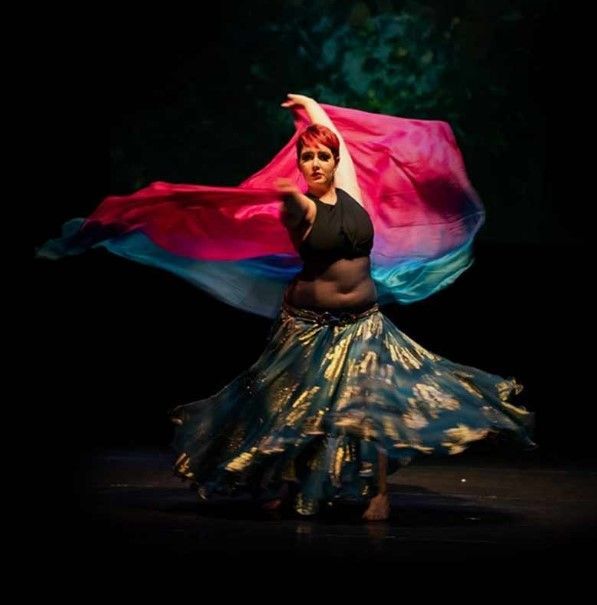 A Woman In A Blue And Gold Skirt Is Dancing In The Dark — Global Dance Collective In West End, QLD