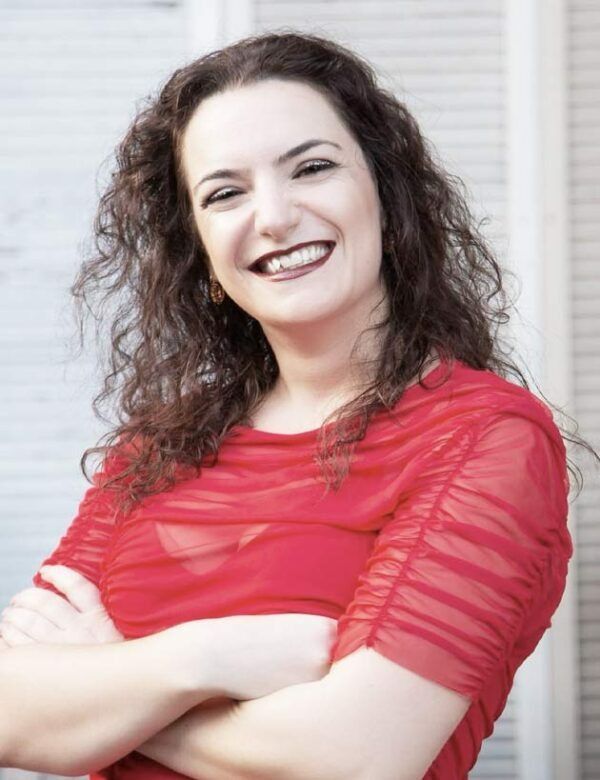 A Woman In A Red Dress Is Smiling With Her Arms Crossed — Global Dance Collective In West End, QLD