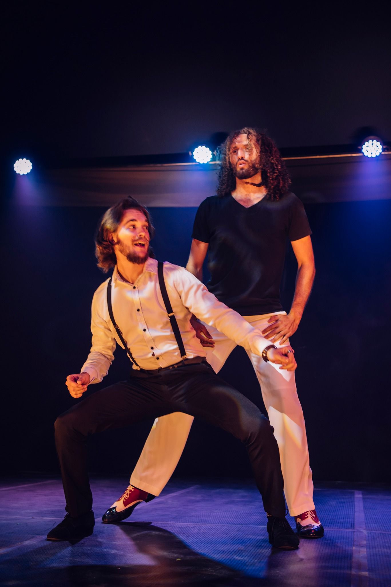 Two Men Are Dancing on a Stage in a Dark Room — Global Dance Collective In West End, QLD
