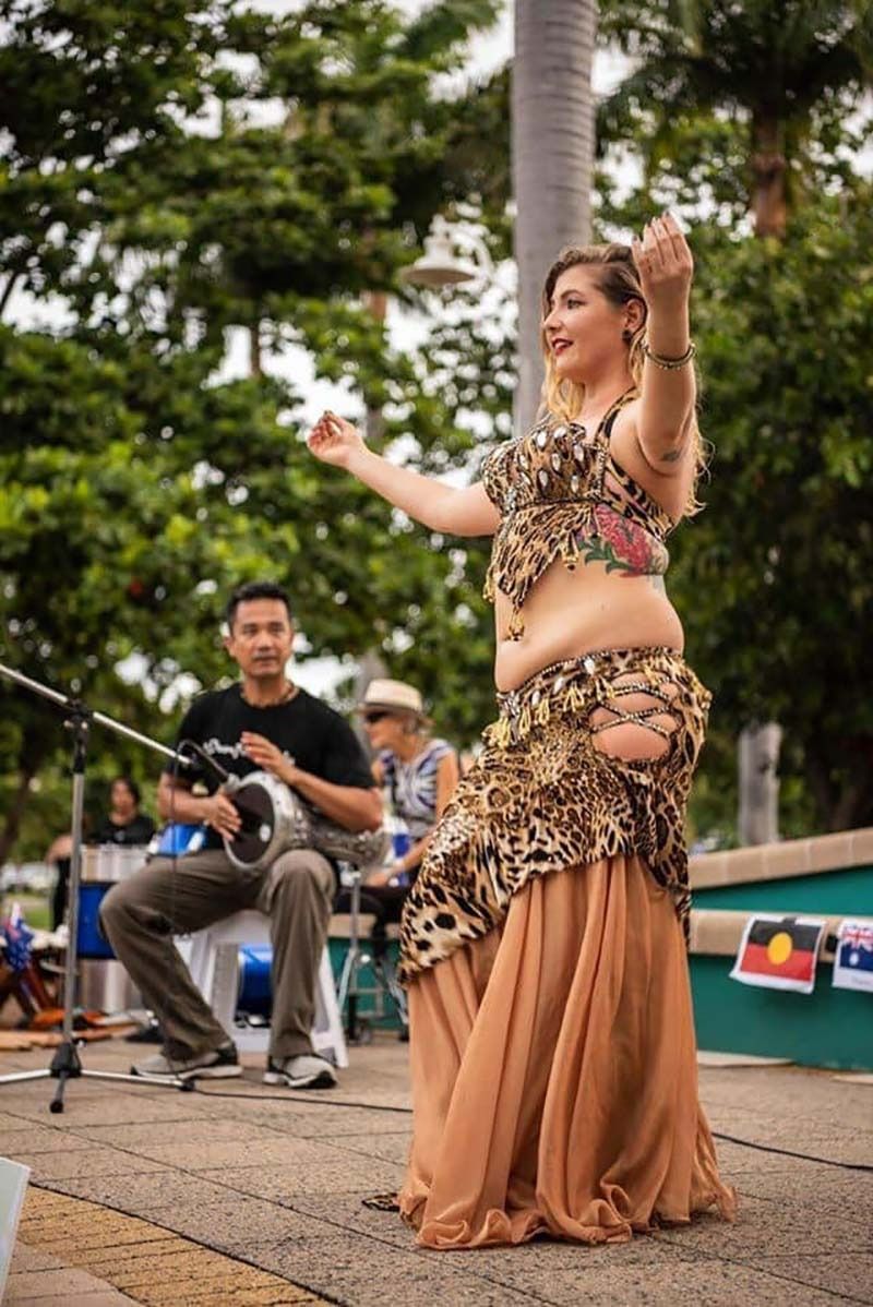 A Woman Is Dancing In Front Of A Man Playing A Drum — Global Dance Collective In West End, QLD