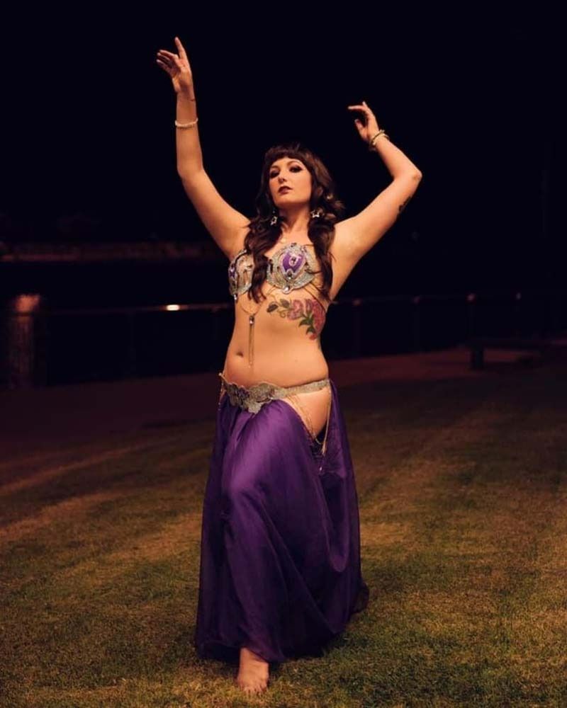 A Woman In A Purple Dress Is Dancing In The Grass At Night — Global Dance Collective In West End, QLD